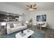 Bright living room with neutral tones, seamlessly connecting to an open kitchen and dining area at 12228 S Pewaukee St, Phoenix, AZ 85044