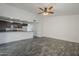 Open living room featuring gray plank flooring and ample natural light, perfect for relaxation at 12228 S Pewaukee St, Phoenix, AZ 85044