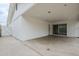 Covered patio with white walls, sliding glass door, and concrete flooring at 12228 S Pewaukee St, Phoenix, AZ 85044