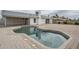 Backyard pool with brick pavers, adjacent to home with white trim at 12228 S Pewaukee St, Phoenix, AZ 85044