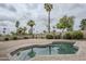 Backyard pool surrounded by brick pavers, with mature palm trees at 12228 S Pewaukee St, Phoenix, AZ 85044