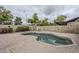 Backyard featuring a brick-lined pool and a well-maintained landscaped area at 12228 S Pewaukee St, Phoenix, AZ 85044
