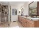 Luxurious bathroom featuring a glass-enclosed shower, double sinks with granite countertops, and ample storage, providing convenience and style at 12686 N 95Th Way, Scottsdale, AZ 85260