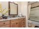 Bathroom with granite countertop, tiled floors, framed mirror and shower/tub combo at 12686 N 95Th Way, Scottsdale, AZ 85260
