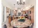 Bright eat-in kitchen featuring granite countertops, wooden cabinets, stainless appliances, and a charming breakfast nook perfect for casual dining at 12686 N 95Th Way, Scottsdale, AZ 85260