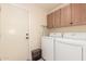 Laundry room featuring a full size washer and dryer and upper cabinets at 12686 N 95Th Way, Scottsdale, AZ 85260