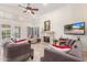 Spacious living room with vaulted ceilings, tiled floors, neutral paint, fireplace, and French doors, creating an inviting and comfortable atmosphere at 12686 N 95Th Way, Scottsdale, AZ 85260