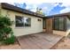Back patio offers a space for outdoor entertaining with a secure door and landscaped yard at 131 N Higley Rd # 51, Mesa, AZ 85205