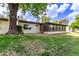 Expansive backyard features lush lawn, mature trees, and an enclosed sunroom at 131 N Higley Rd # 51, Mesa, AZ 85205