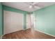 Bedroom featuring laminate floors, ceiling fan and access to the en suite bathroom at 131 N Higley Rd # 51, Mesa, AZ 85205