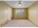 Large carpeted bedroom featuring a ceiling fan and a window that provides natural light at 131 N Higley Rd # 51, Mesa, AZ 85205