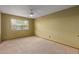 Spacious carpeted bedroom with a ceiling fan and a window providing natural light at 131 N Higley Rd # 51, Mesa, AZ 85205