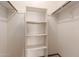 Walk-in closet featuring wall-mounted shelves and metal rods for hanging clothes at 131 N Higley Rd # 51, Mesa, AZ 85205