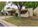 Charming tan home with a covered driveway and a beautifully maintained front yard at 131 N Higley Rd # 51, Mesa, AZ 85205
