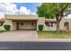 Tan single-story home featuring a covered parking space and manicured landscaping at 131 N Higley Rd # 51, Mesa, AZ 85205