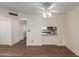 Open-concept living room with hardwood floors, fan, and access to the kitchen at 131 N Higley Rd # 51, Mesa, AZ 85205