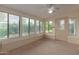 Bright sun room featuring a ceiling fan, multiple windows, and an exterior door at 131 N Higley Rd # 51, Mesa, AZ 85205