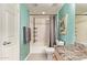 Bathroom with turquoise walls, a single sink, a shower over bath, and a grey shower curtain at 14250 W Wigwam Blvd # 722, Litchfield Park, AZ 85340