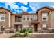 Charming two-story townhome featuring a private balcony and covered entry at 14250 W Wigwam Blvd # 722, Litchfield Park, AZ 85340