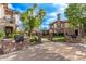Beautiful apartment complex entrance with landscaped walkway and stone accents under a blue sky at 14250 W Wigwam Blvd # 722, Litchfield Park, AZ 85340