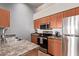 Efficient kitchen featuring stainless steel appliances and wood cabinets with granite countertops at 14250 W Wigwam Blvd # 722, Litchfield Park, AZ 85340