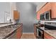 Compact kitchen area with stainless steel appliances and wood cabinets at 14250 W Wigwam Blvd # 722, Litchfield Park, AZ 85340