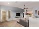 Bright living room with a gray accent wall, ceiling fan, and a door to the exterior at 14250 W Wigwam Blvd # 722, Litchfield Park, AZ 85340
