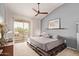 Calming main bedroom with a ceiling fan and large window bringing in natural light at 14250 W Wigwam Blvd # 722, Litchfield Park, AZ 85340