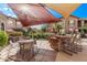 Outdoor patio area featuring comfortable seating, a shaded awning, and a built-in grill at 14250 W Wigwam Blvd # 722, Litchfield Park, AZ 85340