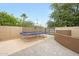Backyard features trampoline, mature trees, and beautiful landscaping creating an inviting outdoor space at 1444 E Myrna Ln, Tempe, AZ 85284
