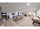 Spacious basement game room with a pool table, shuffleboard, arcade game, and laminate flooring at 1444 E Myrna Ln, Tempe, AZ 85284