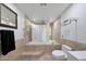 Clean bathroom features a tiled bathtub with shower, toilet and neutral wall-to-wall tiling at 1444 E Myrna Ln, Tempe, AZ 85284
