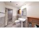 Neutral bathroom with pedestal sink, framed mirror, and tiled walk-in shower at 1444 E Myrna Ln, Tempe, AZ 85284