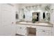 Well-lit bathroom featuring a double vanity with white cabinets and stylish fixtures at 1444 E Myrna Ln, Tempe, AZ 85284
