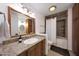 Bathroom featuring granite countertops, wood cabinets, and a tub with a shower at 1444 E Myrna Ln, Tempe, AZ 85284