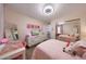 Bright bedroom with soft pink decor, mirrored closet doors, and comfortable furnishings at 1444 E Myrna Ln, Tempe, AZ 85284