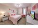 Cozy bedroom featuring pink accents, comfortable bed, and a well-lit vanity area at 1444 E Myrna Ln, Tempe, AZ 85284