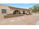 Elegant home exterior featuring arched entryways, a fountain, desert landscaping, and a brick walkway at 1444 E Myrna Ln, Tempe, AZ 85284