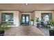 Stylish front entrance with double doors, potted plants, and brick-paved patio at 1444 E Myrna Ln, Tempe, AZ 85284