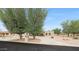 Front exterior of a single-story home with a circular driveway and mature trees at 1444 E Myrna Ln, Tempe, AZ 85284