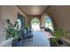 Charming front porch featuring an arched facade, outdoor seating, and potted plants at 1444 E Myrna Ln, Tempe, AZ 85284