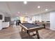 Open concept basement game room featuring a pool table, kitchenette, and foosball table at 1444 E Myrna Ln, Tempe, AZ 85284