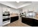 Bright kitchen displays white and dark wood cabinetry, stainless steel appliances, and modern finishes at 1444 E Myrna Ln, Tempe, AZ 85284