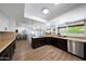 Well-equipped kitchen features dark wood cabinets, stainless steel appliances, and modern countertops at 1444 E Myrna Ln, Tempe, AZ 85284