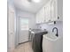 Well lit laundry room with tile floors, modern washer and dryer, and utility sink at 1444 E Myrna Ln, Tempe, AZ 85284