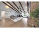 Spacious living room with wood beam vaulted ceilings, wood burning fire place and sliding barn door at 1444 E Myrna Ln, Tempe, AZ 85284