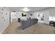 Inviting living room is furnished with comfortable seating, neutral tones, and multiple access points to other rooms at 1444 E Myrna Ln, Tempe, AZ 85284