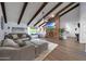 Inviting living room featuring vaulted ceilings, exposed beams, stone fireplace, and comfortable seating at 1444 E Myrna Ln, Tempe, AZ 85284