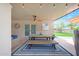 Spacious covered patio includes seating, dining table, and view of the backyard at 1444 E Myrna Ln, Tempe, AZ 85284