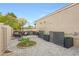 Enclosed patio with pavers, a circular garden, a seating area, and decorative planters at 1444 E Myrna Ln, Tempe, AZ 85284